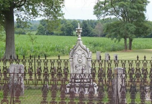 Ornate fence surrounding three grave markers